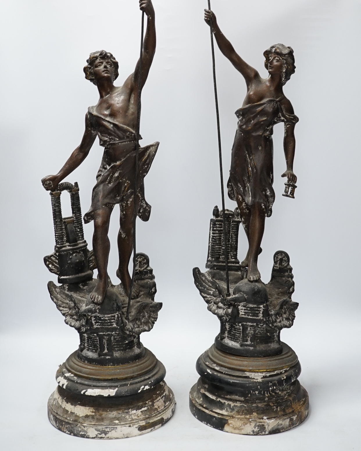 A pair of late 19th century, spelter classical figures on stands, tallest 78cm high